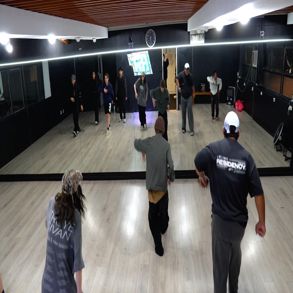 A full group learning choreography together in the HIT studio